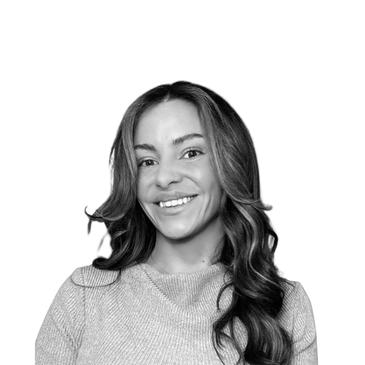 Smiling woman with long hair in a cozy sweater.
