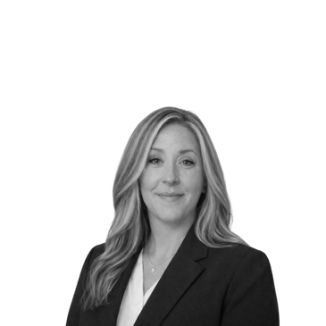 Professional woman in business attire smiling confidently.