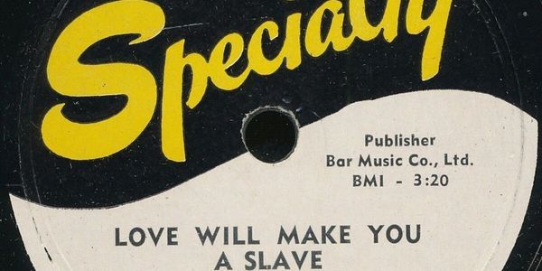 Close-up of a vintage vinyl record label with the song "Love Will Make You a Slave."