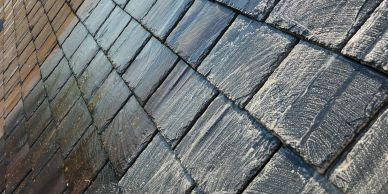 Close-up of textured stone tiles on floor or wall.