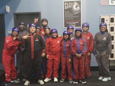 Students in red flight suits.

