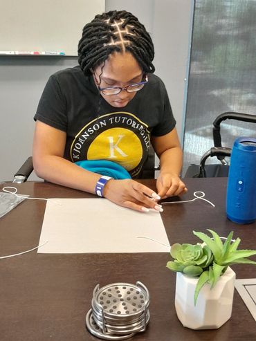 Student working on desktop project.
