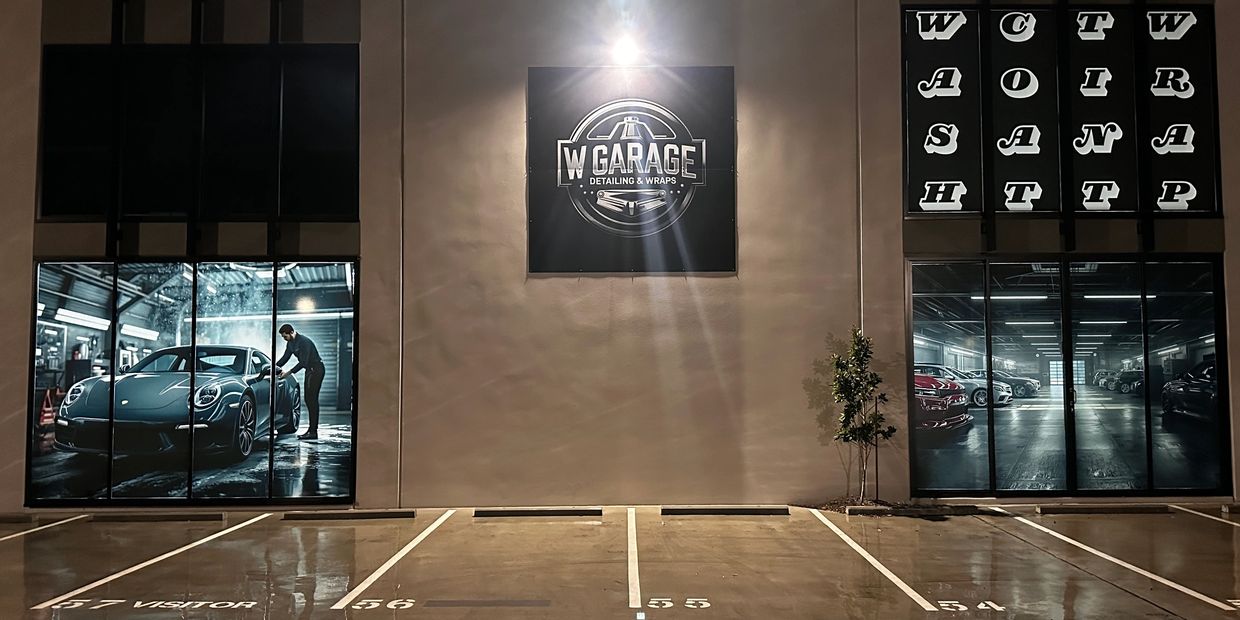 Garage entrance with car detailing ads and empty parking spaces.