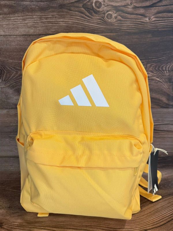 Yellow Adidas backpack with white logo.