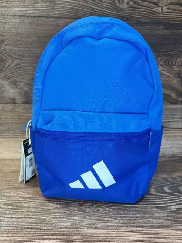 Small blue Adidas backpack with logo.