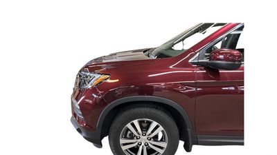 Technician repairs a car at a northeast Portland auto body.