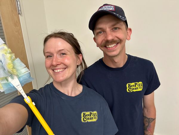 Two smiling people wearing Keep Pitt Clean shirts.