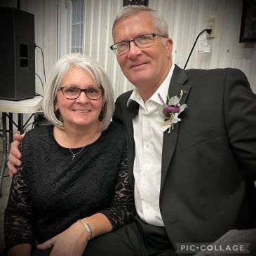 Smiling couple dressed formally indoors.