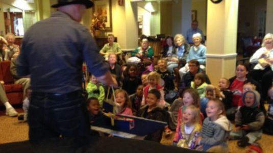 magic show at an assisted living community with a nearby child care facility joining up for a show