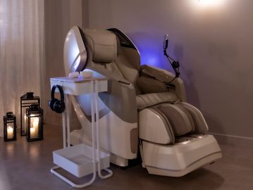 Osaki massage chair in a spa environment with candles