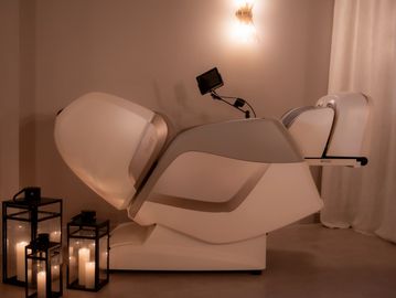 Osaki massage chair in the zero gravity position with candles