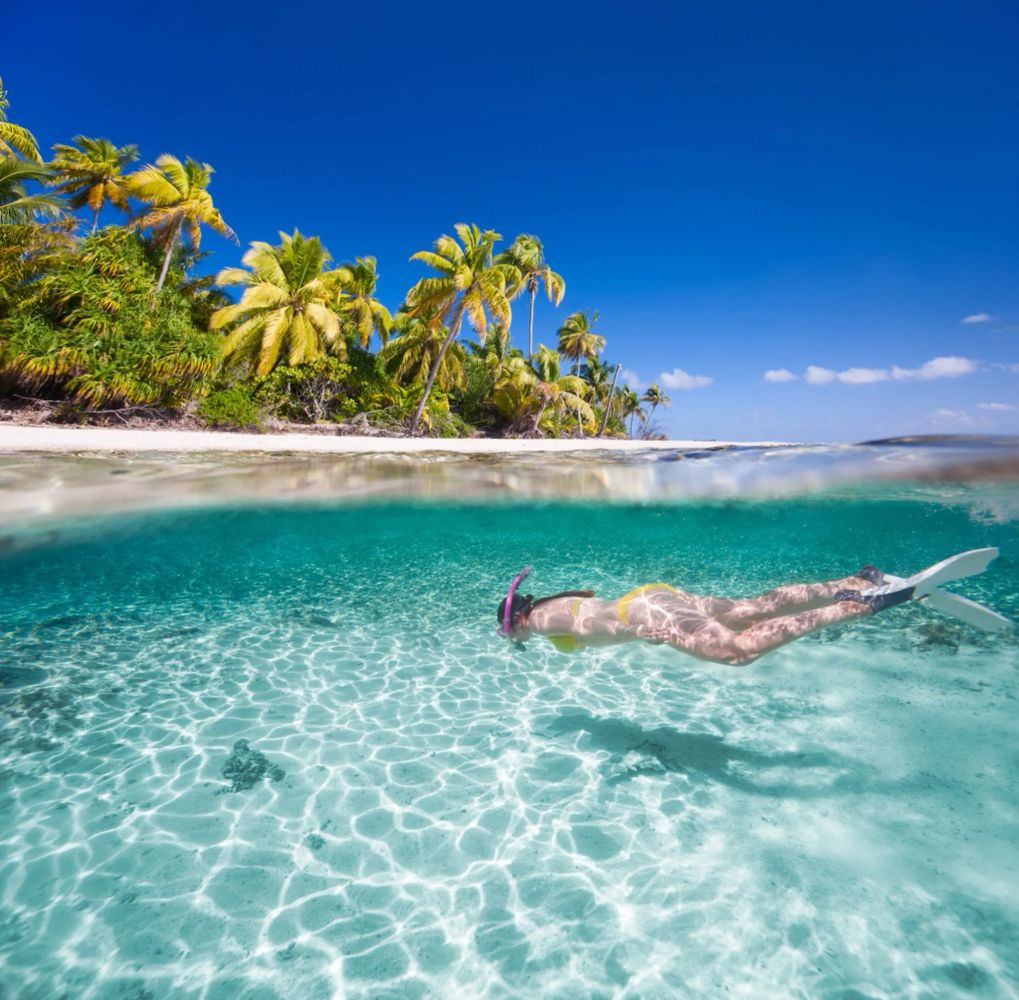 Person snorkeling in clear blue water