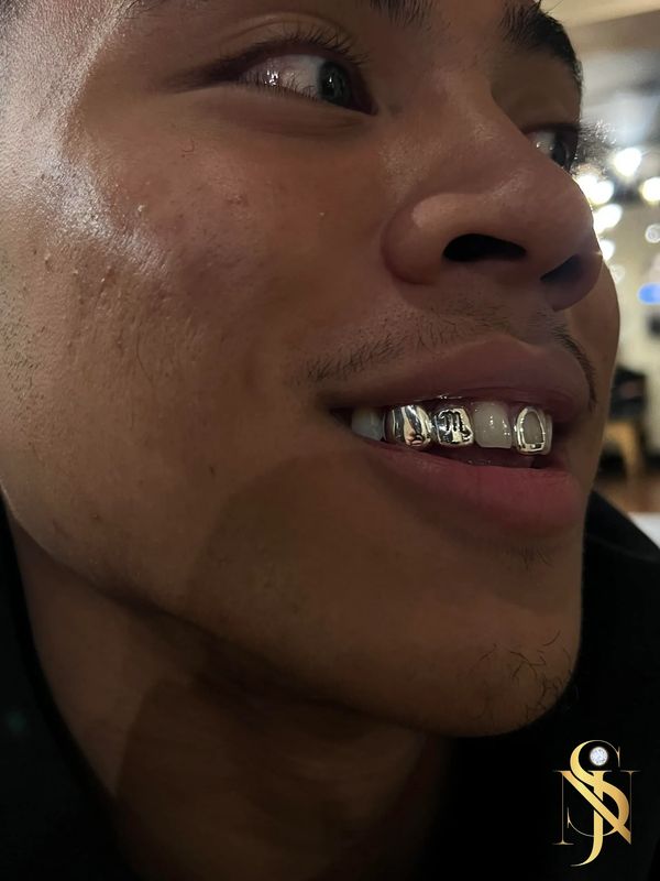 Silver Custom Grillz With a Custom Scorpio Design 