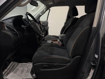 Interior view of a car showing the driver's and passenger's seats with black upholstery.