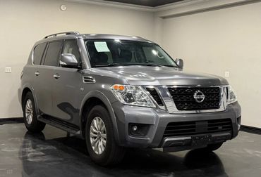 A gray Nissan SUV parked indoors with a clean, polished look.