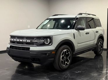 White Ford Bronco SUV parked indoors with modern design.
