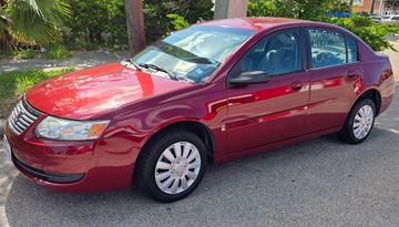 Red sedan parked on a street.