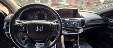 Interior view of a Honda car dashboard and steering wheel.