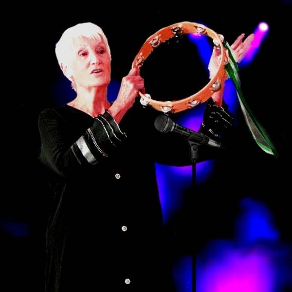 Old woman with short hair in a black dress in a retro style singing on the stage
