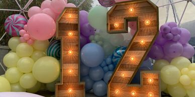 Light up numbers in an igloo, with pastel balloons behind. 