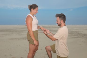 Man proposing marriage to woman on the beach.