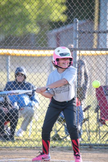 Young softball player ready to hit the ball during a game.