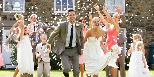 A couple running across the wedding ground