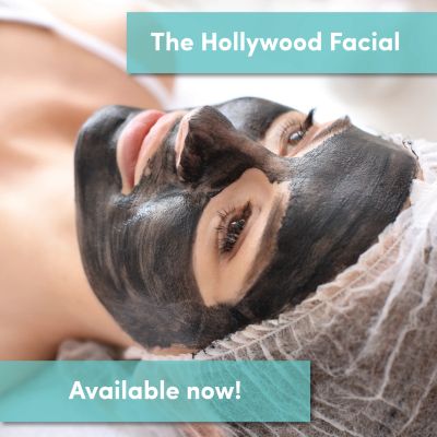 Woman enjoying a Hollywood Facial with a black mask.