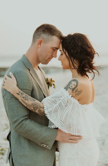 Just married couple embrace in Long Beach, NY.