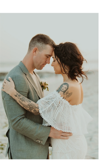 Just married couple embrace in Long Beach, NY.