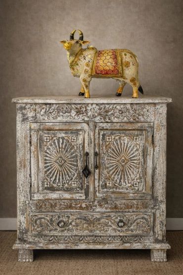 Ornate vintage wooden cabinet with a decorative bull statue on top.