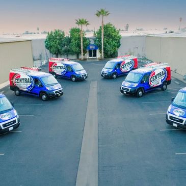 Fleet of six Central Heating & Cooling vans parked in a lot.