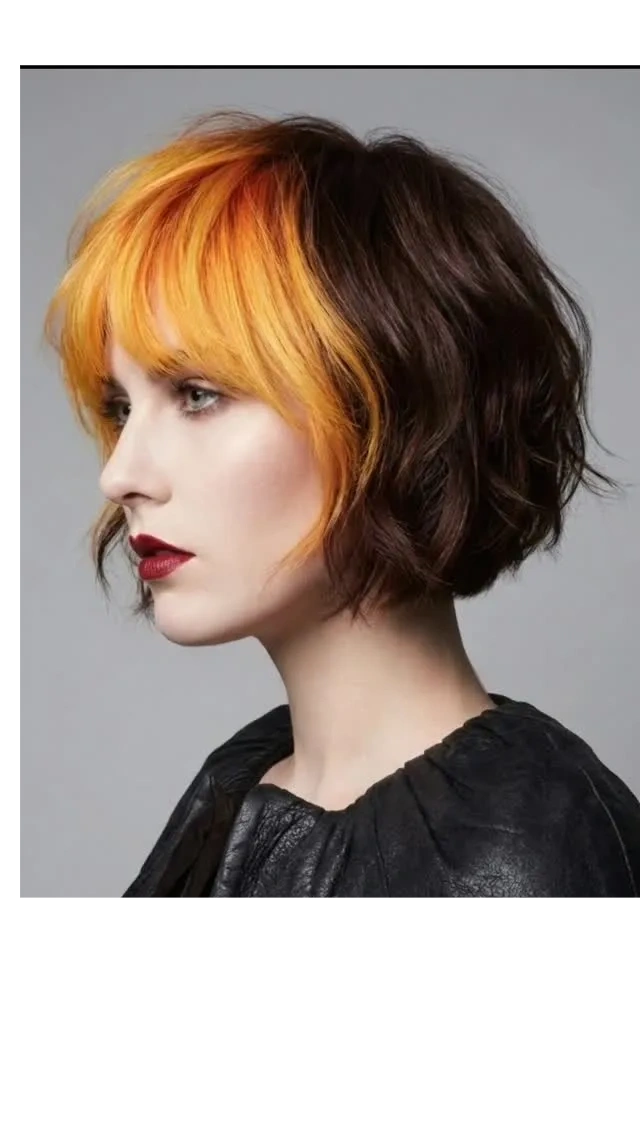 Profile of a woman with a two-tone bob haircut, featuring vibrant orange front and dark brown back.