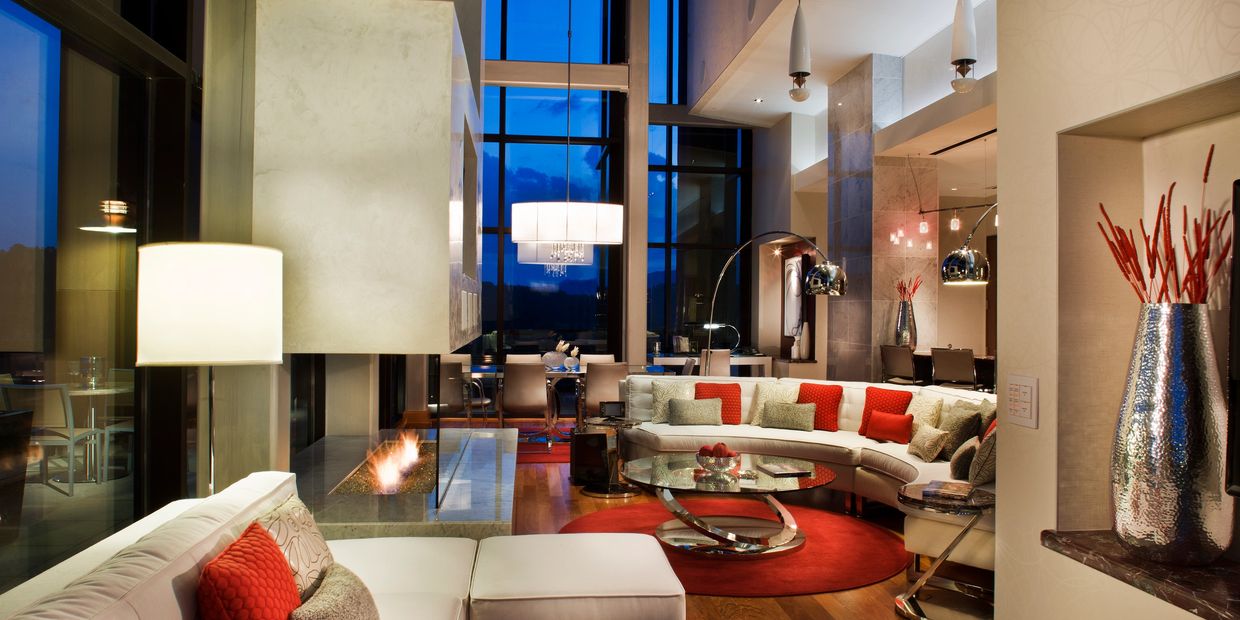 Hotel Suite in the evening with living, dining, and fireplace.