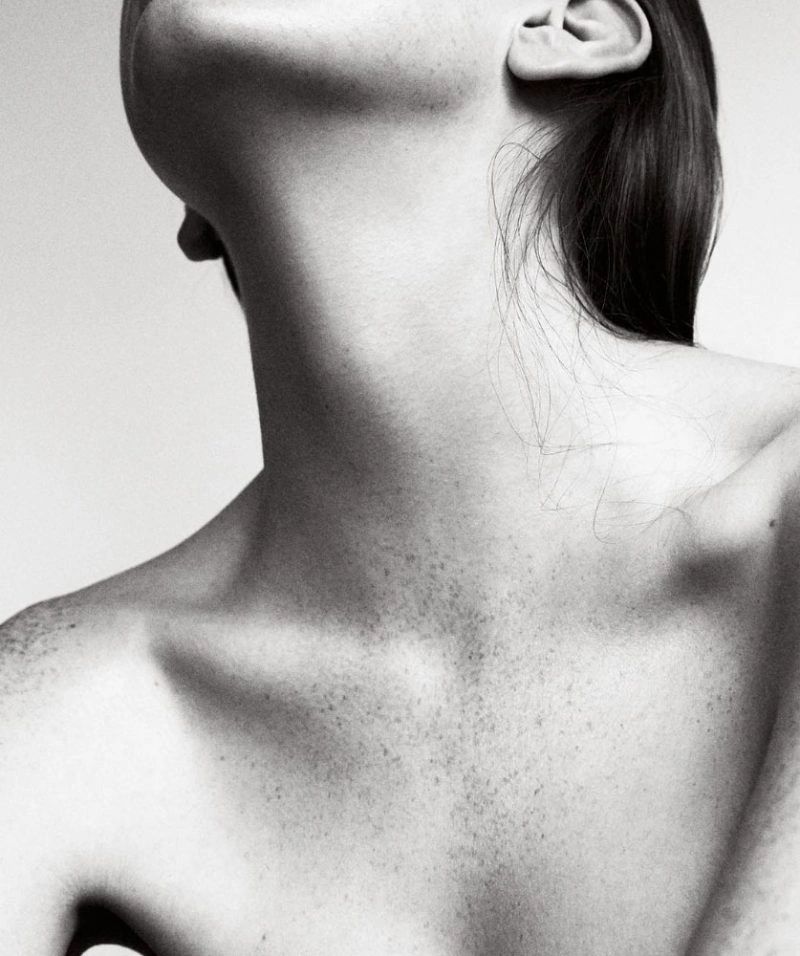 Black and white close-up of a neck and shoulder.