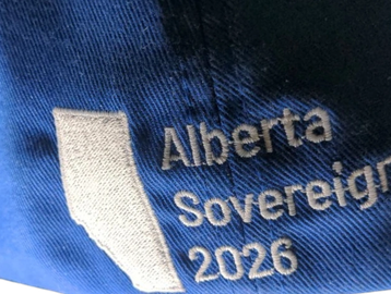 Blue fabric with embroidery of Alberta and text 'Sovereign 2026'.