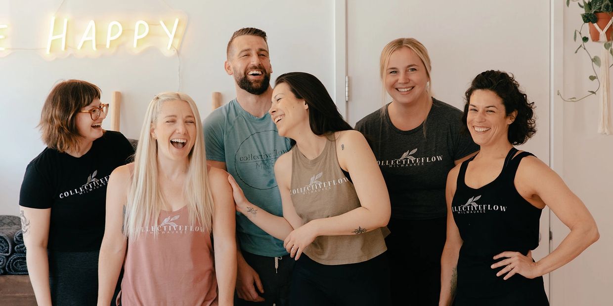 Group of friends laughing together indoors.
