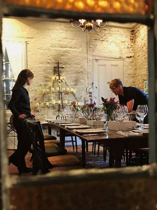 Bryan is setting the table for guests for a wedding.