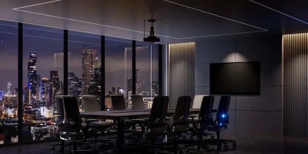 Modern boardroom at night with city skyline view.