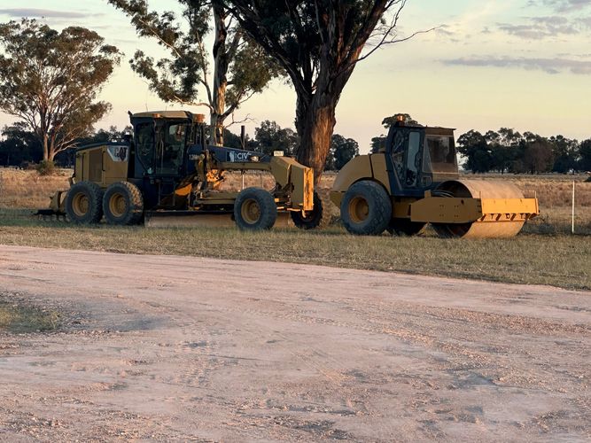 Grader and roller after grading road. In Young NSW and Hilltops region. Road maintenance.
