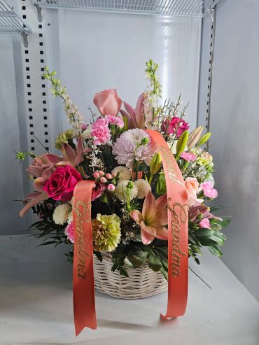 A colorful flower basket with pink and white blooms.