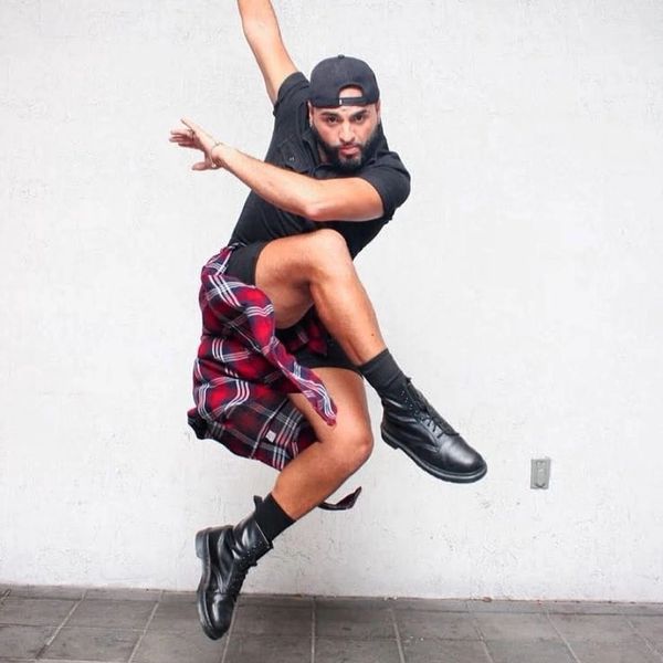 Man jumping in a dynamic dance pose.