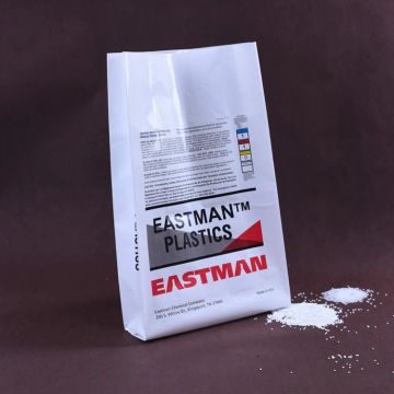 Bag of Eastman plastics resin with some spilled powder.