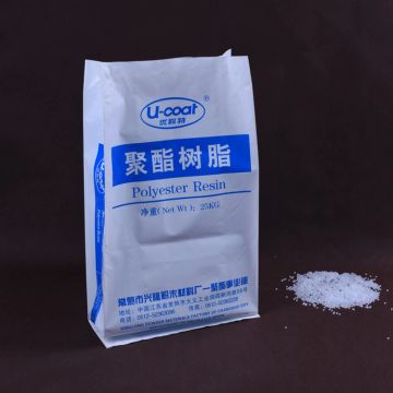 A bag of polyester resin with some resin spilled beside it.