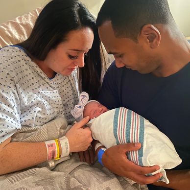 Momma and Dad holding newborn baby 