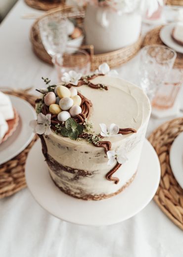 easter egg cake on white cake stand and tablescape made by Chicago Food Stylist Nicole Triebe
