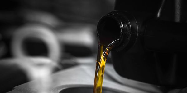 Oil being poured from a black container.
