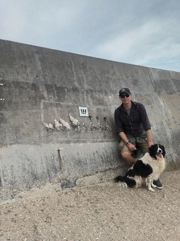 Paul Cowling (and Jessie) of Choughed by the Banksy 'Great British Spraycation mural in  Norfolk. 