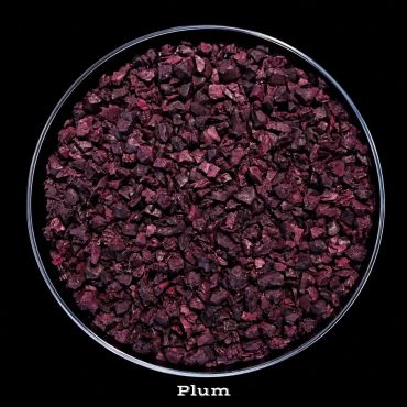 Dried plum pieces in a round container.
