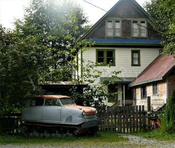 Old car converted into a snow cat and heritage home in Stewart BC
